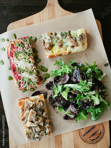 Deliciously looking pizza slices with a fresh salad.