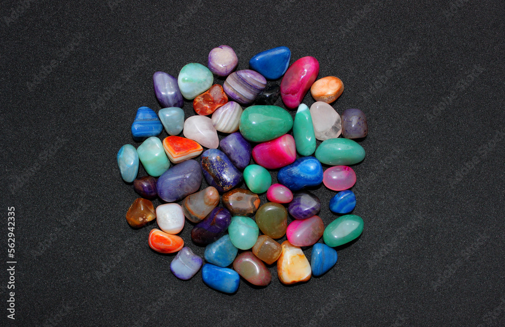 Bunch of processed and polished semi-precious quartz stones on a black surface top view Bunch of processed and polished semi-precious quartz stones on a black surface top view