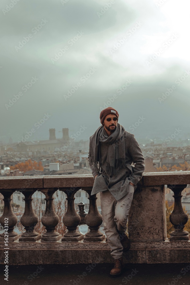 photo of a man posing with the panorama of Paris behind him photo of a man posing with the panorama of Paris behind him