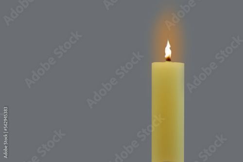 A wax candle burned on a gray background. Copy space