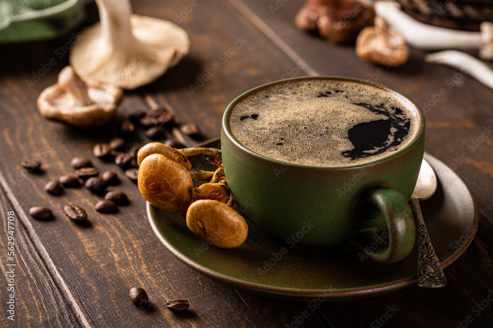 Coffee with mushrooms in green cup on wooden background. New Superfood trendy healthy concept with copy space, selective focus. Coffee with mushrooms in green cup on wooden background. New Superfood trendy healthy concept with copy space, selective focus.