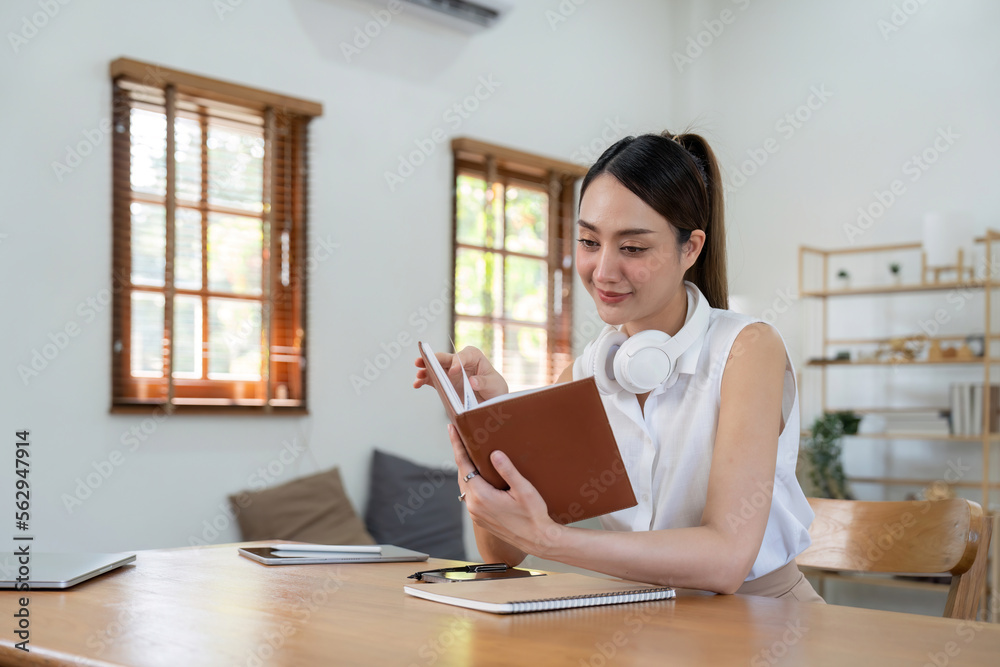 Beautiful young aisna woman reading book at home Beautiful young aisna woman reading book at home