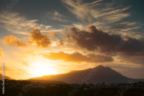 Houses of Procida in magic sunset with the island of Ischia in the background.