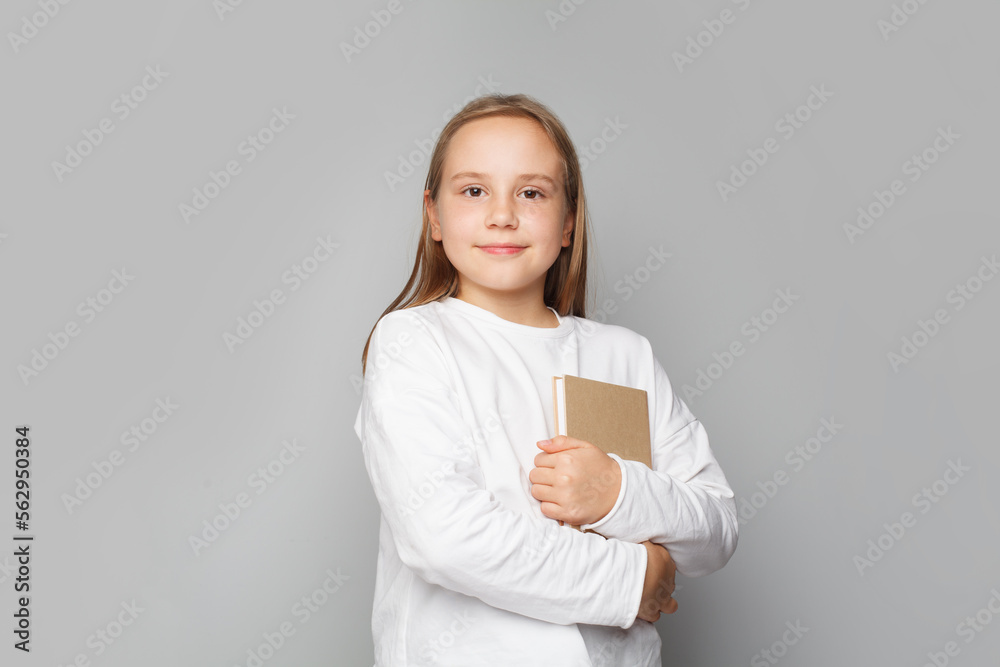 Funny smiling child school girl with books against white studio wall banner background Funny smiling child school girl with books against white studio wall banner background