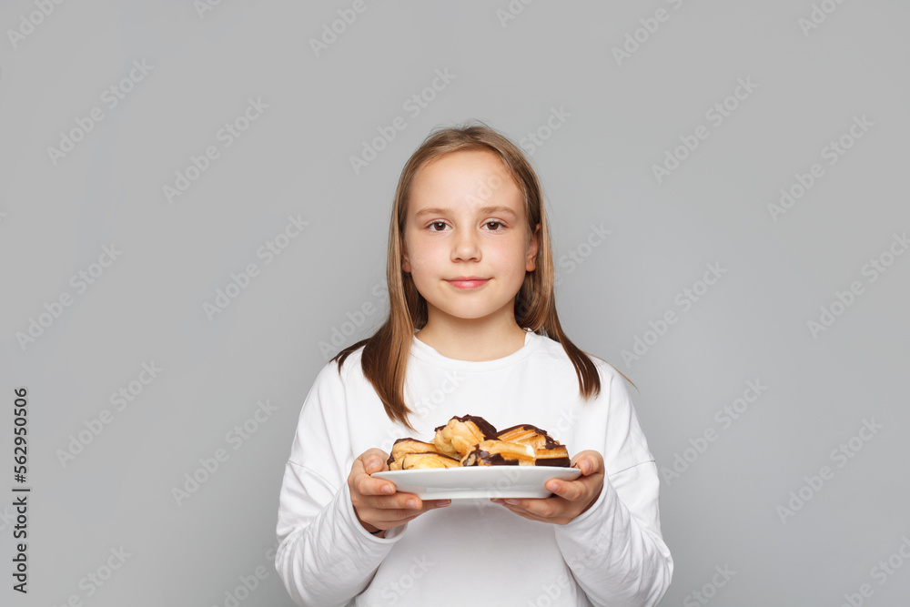 Cute little girl with chocolate dessert on grey background