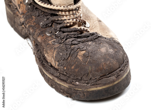 Part of old dirty hiking boot on white background photo