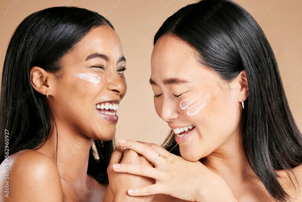 Happy, beauty and skincare women with cream for face isolated on a beige studio background. Wellness, smile and Asian model friends with sunscreen for love of cosmetics and dermatology on a backdrop Happy, beauty and skincare women with cream for face isolated on a beige studio background. Wellness, smile and Asian model friends with sunscreen for love of cosmetics and dermatology on a backdrop