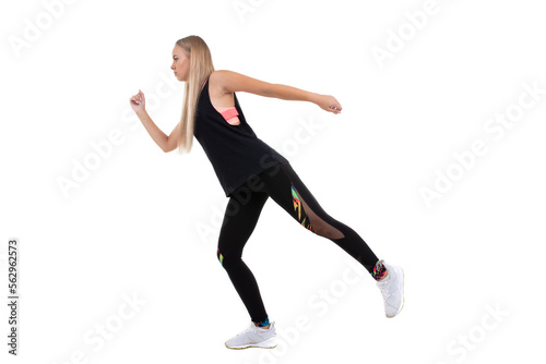 Athletic young woman in a pink top, leggings and sneakers squats on a white background