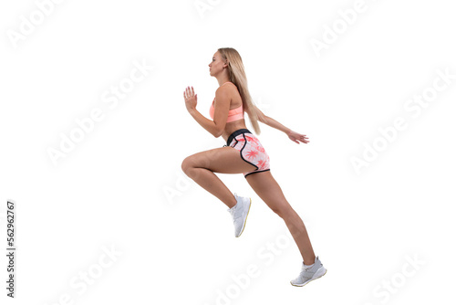 A sporty young woman in a pink top, shorts and sneakers runs forward on a white background.Isolated