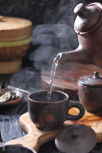 Tea is an aromatic beverage prepared by pouring hot or boiling water over cured or fresh leaves of Camellia sinensis, an evergreen shrub native to East Asia which probably originated in the borderland