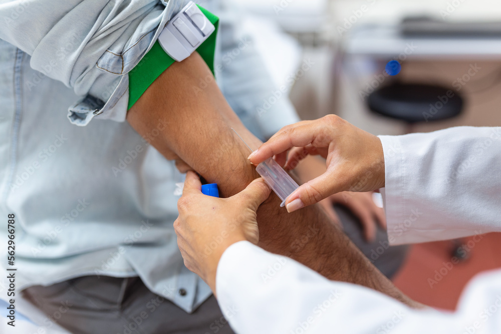 Preparation for blood test by female doctor medical uniform on the table in white bright room. Nurse pierces the patient's arm vein with needle blank tube. Preparation for blood test by female doctor medical uniform on the table in white bright room. Nurse pierces the patient's arm vein with needle blank tube.