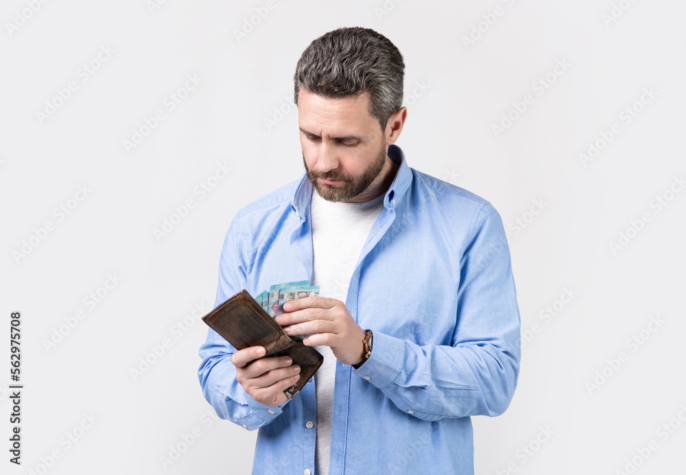 photo of mature man pay money. man pay money isolated on studio background.