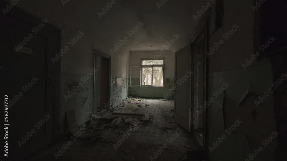 Dark destructed corridor with rooms in forsaken building