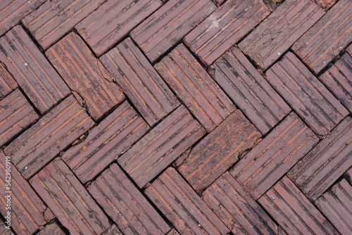 walkway is paved with brown bricks.