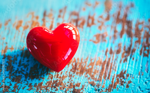 Red heart on a blue wood background concept for love, valentine's day, dating and romance photo