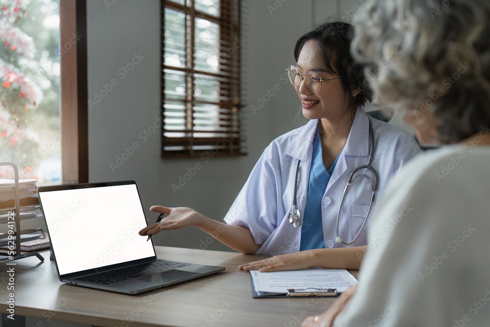 Doctor talking with elderly asian woman. Female primary care physician having conversation with older woman. Elderly Healthcare