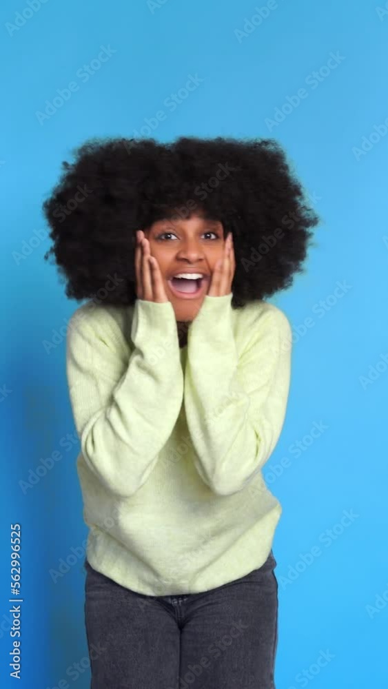 Excited black woman in sweater. Vertical Video. Excited black woman in sweater. Vertical Video.
