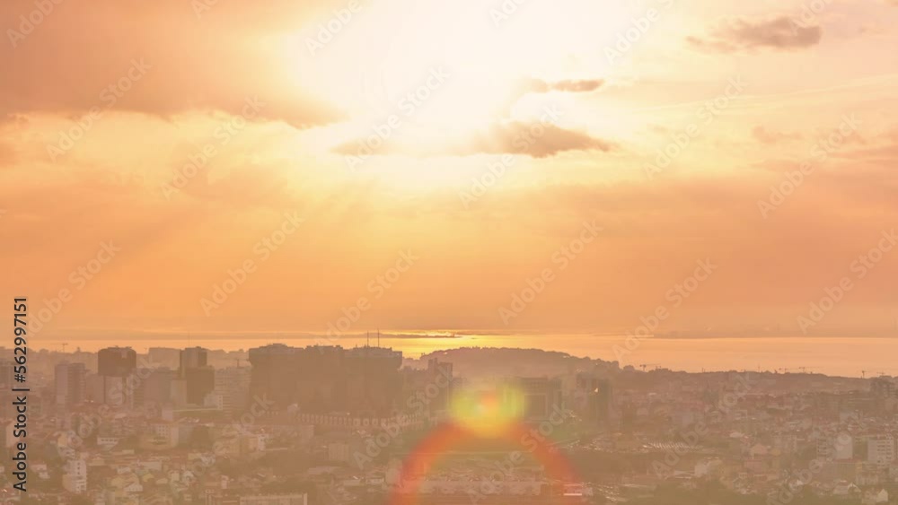 Panoramic sunrise view over Lisbon and Almada from a viewpoint in Monsanto at morning timelapse. Aerial top overview with colorful clouds and rays of light Panoramic sunrise view over Lisbon and Almada from a viewpoint in Monsanto at morning timelapse. Aerial top overview with colorful clouds and rays of light