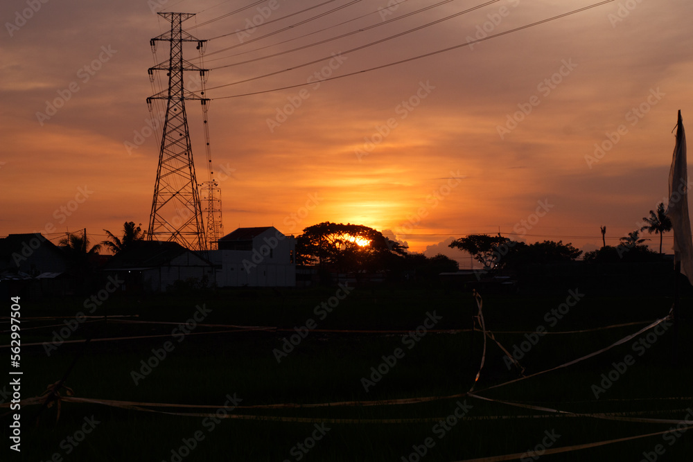 afternoon atmosphere in a village on the edge of a rice field enjoying an orange sunset