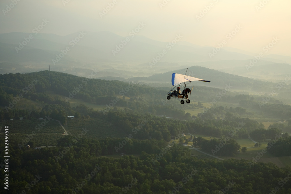 Ultralight trike flies over the apple orchards outside Hendersonville, NC Ultralight trike flies over the apple orchards outside Hendersonville, NC