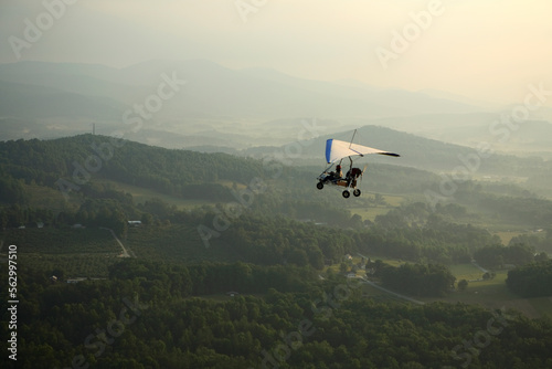 Ultralight trike flies over the apple orchards outside Hendersonville, NC photo