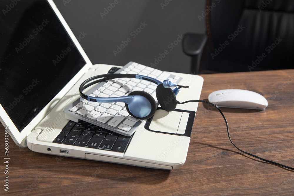 Customer service headset on the computer keyboard. Customer service headset on the computer keyboard.