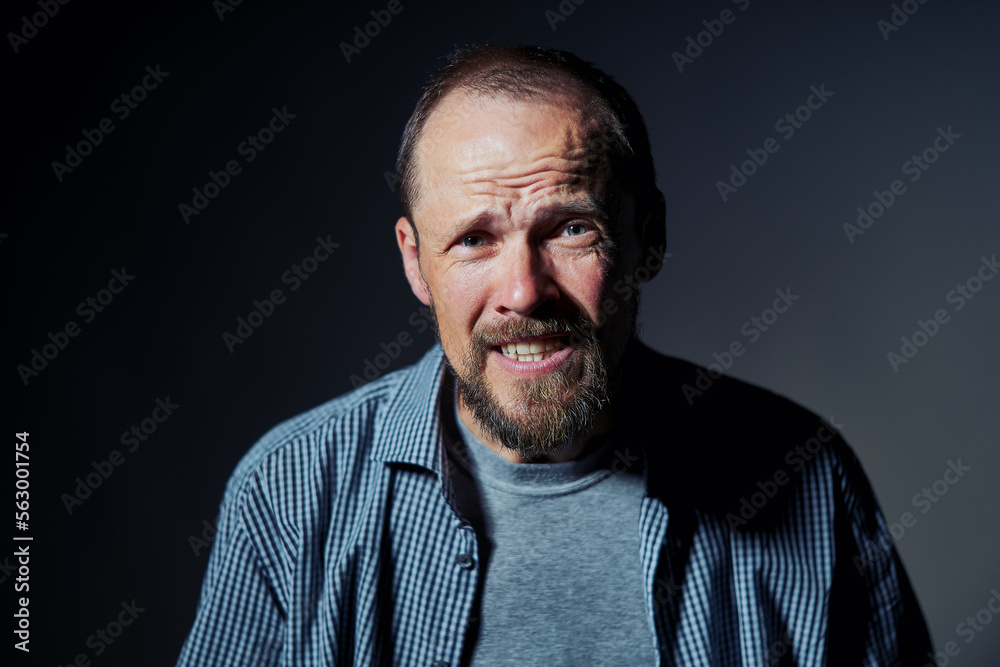 Fototapeta premium Portrait of mature man with confused expression