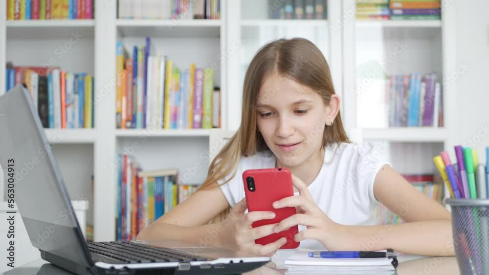 Kid Using Smartphone Studying in Video Conferencing, Child Learning, Writing in Library, Schoolgirl Chatting, Online Education Kid Using Smartphone Studying in Video Conferencing, Child Learning, Writing in Library, Schoolgirl Chatting, Online Education