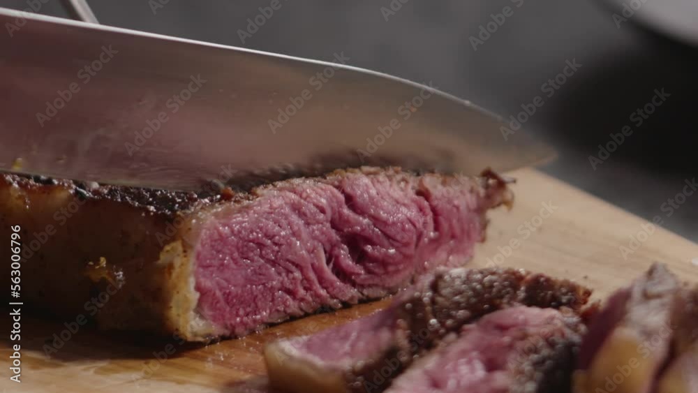 Slow motion slicing new york steak closeup soft vintage look Slow motion slicing new york steak closeup soft vintage look