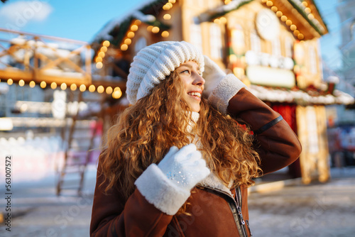 A pretty woman walks around the fair at Christmas. Travelling, lifestyle, adventure, holidays concept.
