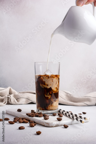 Morning ice coffee with milk or latter in glass and milk jug