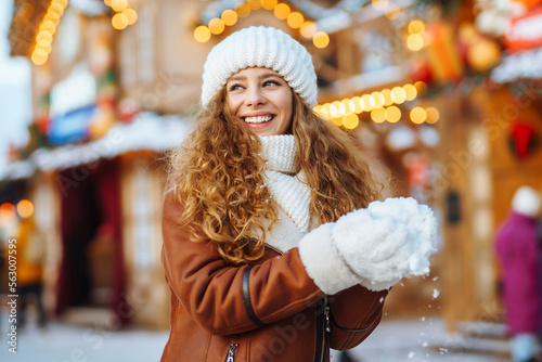 A pretty woman walks around the fair at Christmas. Travelling, lifestyle, adventure, holidays concept.