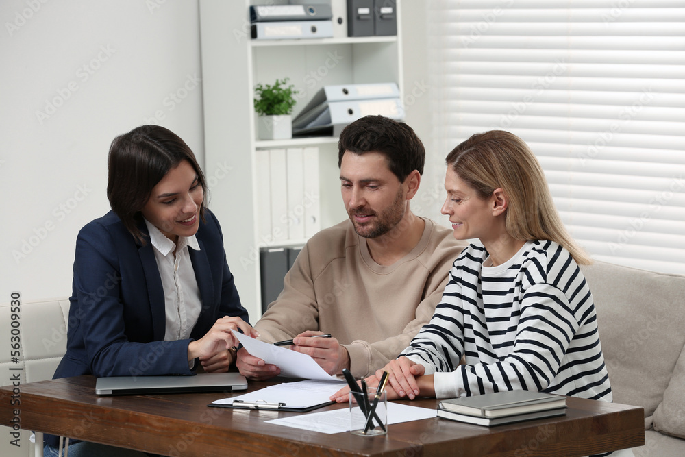 Professional notary working with couple in office Professional notary working with couple in office