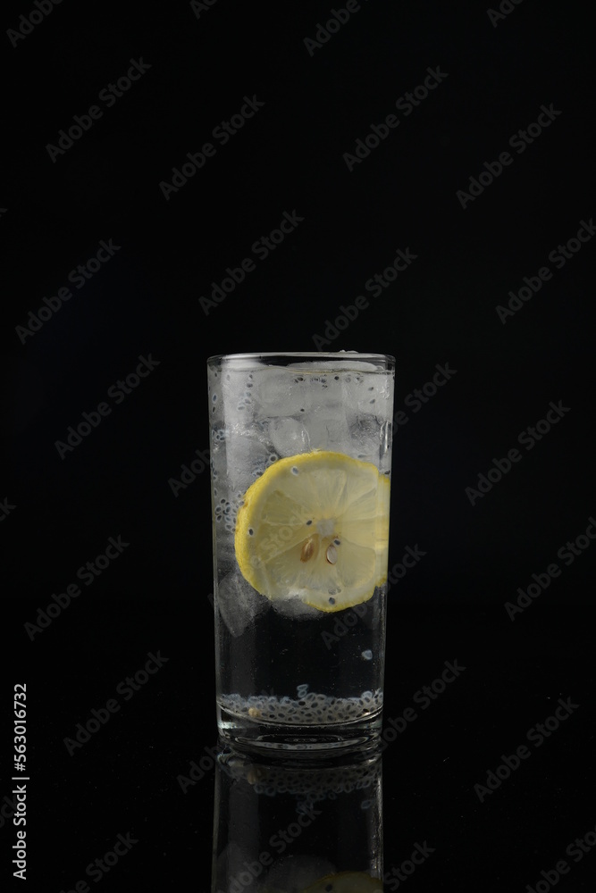 Cold summer refreshment with lemon on black background
