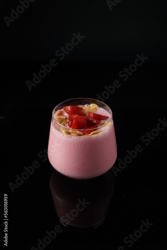 Strawberry smoothie on the black background