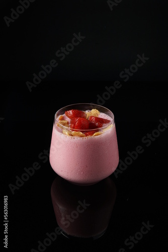 Strawberry smoothie on the black background