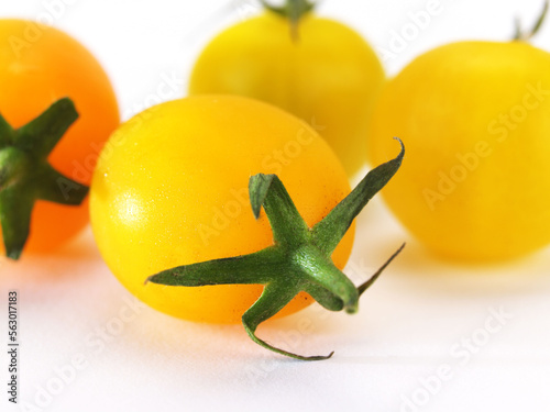 Yellow tomatoes on white background