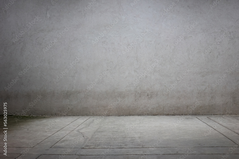 Gray, concrete facade with a sidewalk at night with a cone of light. Neutral urban background. Gray, concrete facade with a sidewalk at night with a cone of light. Neutral urban background.