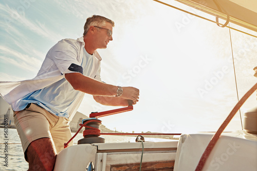 Retirement, luxury yacht and investment for mature man and sailing winch in mast control, wind management or speed. Person, tourism boat and rope handle in wealth holiday and water location vacation