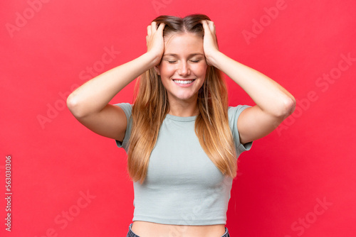Young beautiful woman isolated on red background laughing