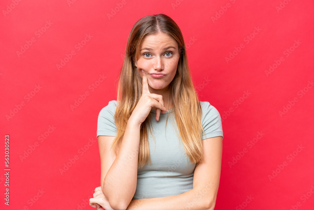 Young beautiful woman isolated on red background and thinking Young beautiful woman isolated on red background and thinking