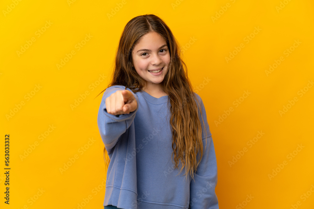 Child over isolated yellow background pointing front with happy expression Child over isolated yellow background pointing front with happy expression