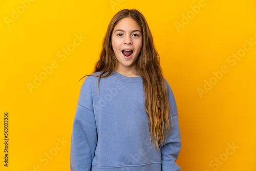 Child over isolated yellow background with surprise facial expression © luismolinero