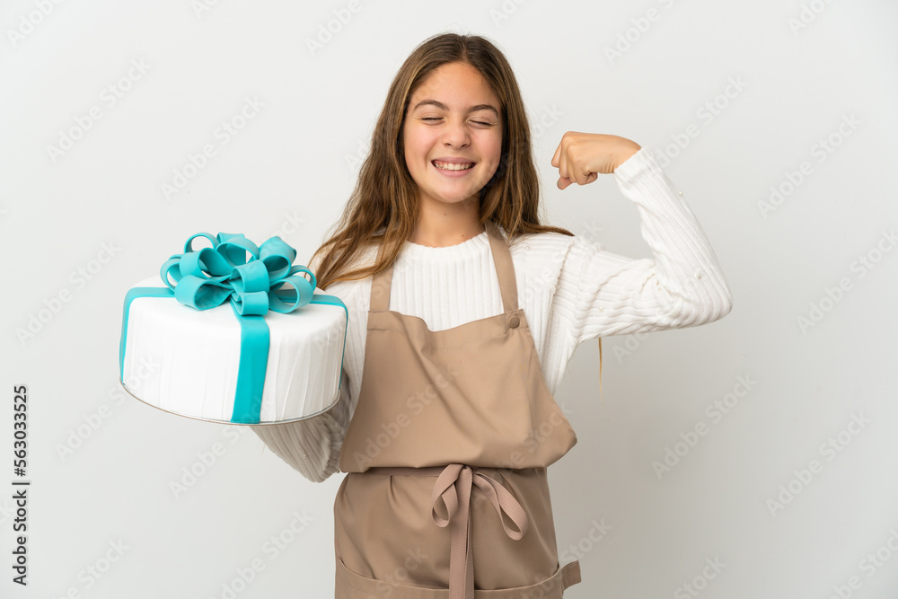 Little girl holding a big cake over isolated white background doing strong gesture Little girl holding a big cake over isolated white background doing strong gesture
