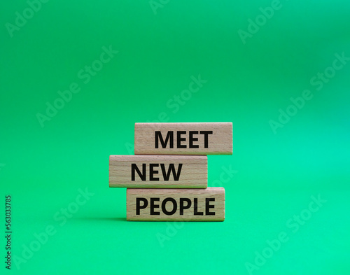 Meet new people symbol. Concept word Meet new people on wooden blocks. Beautiful green background. Business and Meet new people concept. Copy space