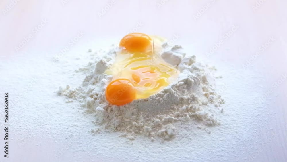 Egg Falling on Flour, Slow Motion 4K. bad shot for a cooking show of egg-flourising wheat flour egg white and egg yolk in one shot eggs fall on the flour and spill around the idea High quality FullHD Egg Falling on Flour, Slow Motion 4K. bad shot for a cooking show of egg-flourising wheat flour egg white and egg yolk in one shot eggs fall on the flour and spill around the idea High quality FullHD