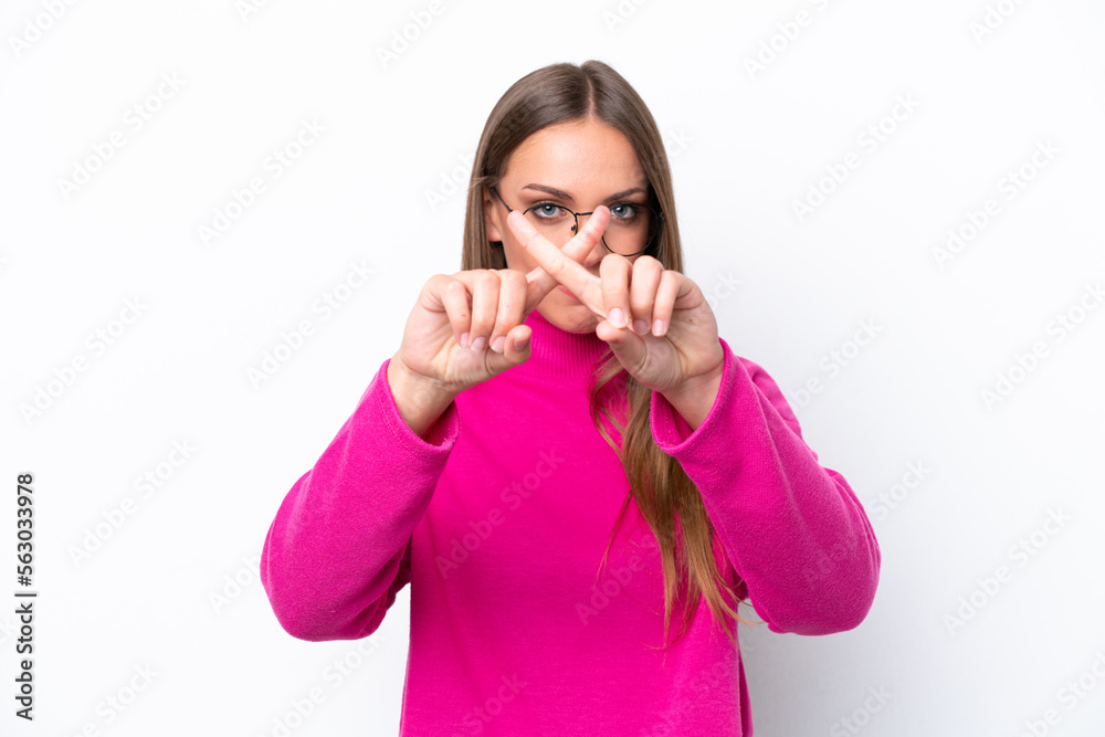 Young caucasian woman isolated on white background making stop gesture with her hand to stop an act Young caucasian woman isolated on white background making stop gesture with her hand to stop an act