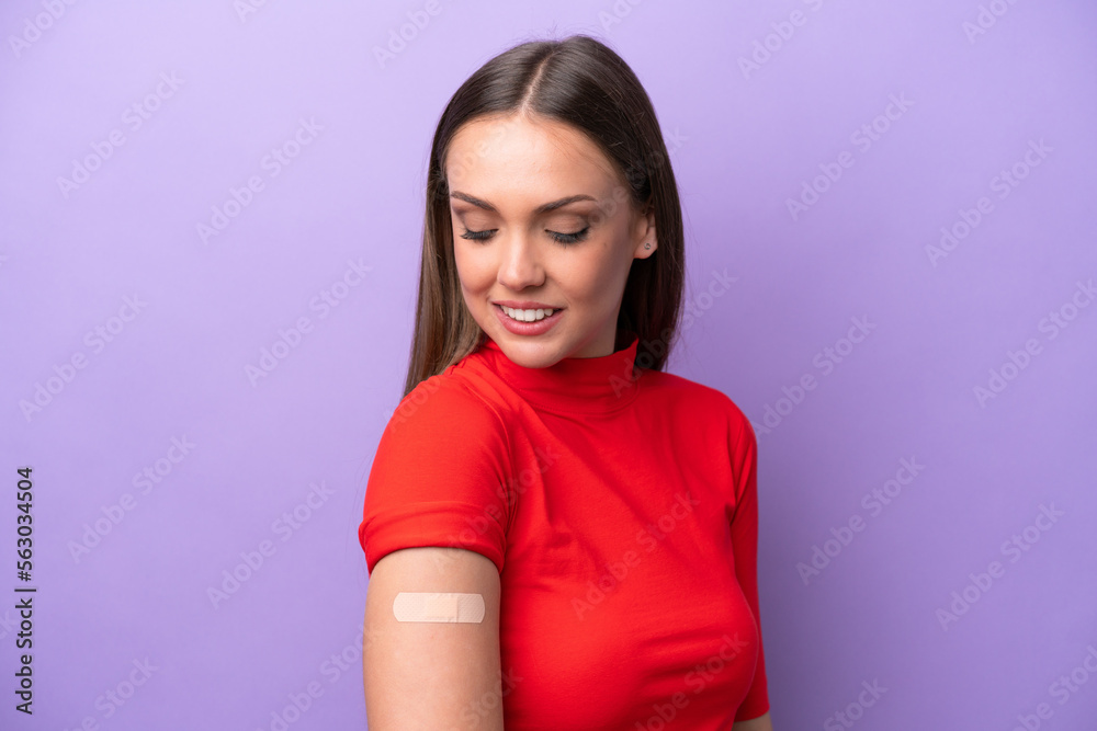Young caucasian woman wearing band aid isolated on purple background with happy expression Young caucasian woman wearing band aid isolated on purple background with happy expression