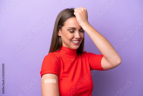 Young caucasian woman wearing band aid isolated on purple background has realized something and intending the solution