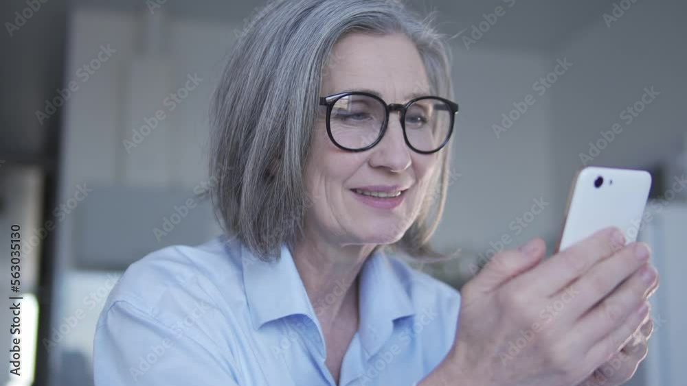 Adult woman nutritionist working on smartphone on post for social networks about dieting and properly eating, consulting online, helping to complete individual menu and to count calories Adult woman nutritionist working on smartphone on post for social networks about dieting and properly eating, consulting online, helping to complete individual menu and to count calories